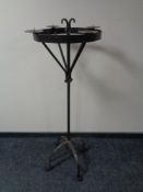A wrought iron floor standing four way candelabra