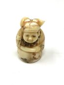 A carved Chinese bone netsuke - Figure holding a sack on back