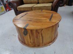 A circular sheesham wood storage coffee table