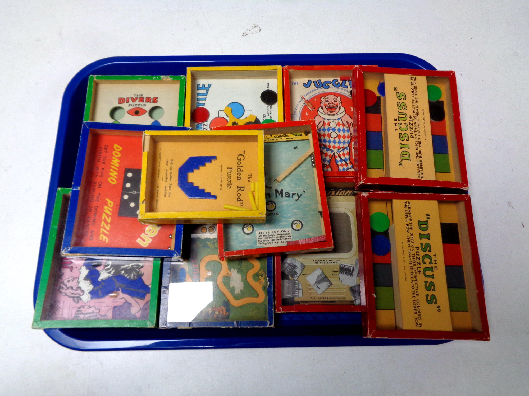 A tray of eleven mid 20th century hand held puzzles