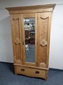 An Edwardian carved pine mirror door wardrobe fitted a drawer beneath CONDITION REPORT: