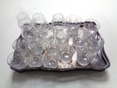 A silver plated gallery tray on claw and ball feet containing assorted lead crystal whisky and