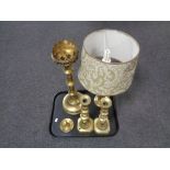 A tray containing brass table lamp with shade, pair of antique brass candlesticks, candle snuffer,