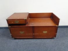 A ship's style four drawer chest with brass drop handles and leather top,