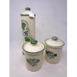 Three Poole pottery lidded storage jars hand-painted with grape design