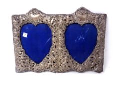 A 20th century silver embossed double heart shaped photo frame