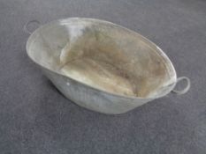 A galvanized metal twin handled wash tub,