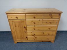 A pine eight drawer chest fitted a cupboard