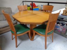 An octagonal pedestal table together with a set of four rail back chairs