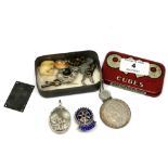 A small Oxo tin containing silver mounted pendant, silver Rotary Hexham badge, coin,