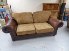 A Burgundy leather and cloth two seater settee