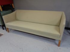 A 20th century continental settee upholstered in a green fabric.