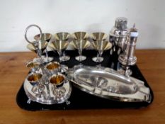 A tray containing antique and later plated wares to include sugar sifter, egg cups on stand,