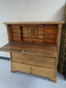 A 19th century continental pine four drawer secretaire chest