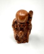 A carved Chinese hardwood netsuke - Elderly Gentleman with staff