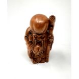 A carved Chinese hardwood netsuke - Elderly Gentleman with staff