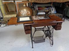 An early 20th century Singer treadle sewing machine in table,