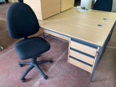 A beech effect three drawer desk, width 153 cm, together with a swivel chair.