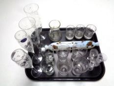 A tray containing an antique opaque glass rolling pin together with assorted drinking glasses to