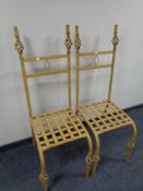 A pair of wrought iron dining chairs