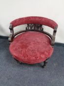 A 19th century low back elbow chair upholstered in a red brocade fabric