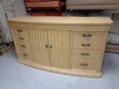 A contemporary double door eight drawer sideboard fitted internal drawers in a washed oak finish