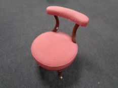 A 19th century mahogany nursing chair upholstered in a pink fabric