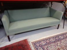 A 20th century continental settee upholstered in a green fabric.