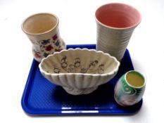 A tray containing a Poole Pottery ribbed vase together with three further vases,