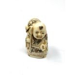 A carved Chinese bone netsuke - Gentleman with sack and fruit
