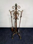 A four piece Victorian style companion set on stand