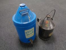 A vintage Esso blue paraffin canister with tap together with a vintage Castrol GTX oil canister/
