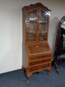 An Edwardian mahogany and walnut arch topped bureau bookcase fitted three drawers beneath