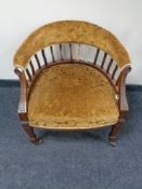 A 19th century mahogany tub armchair upholstered in a gold brocade fabric