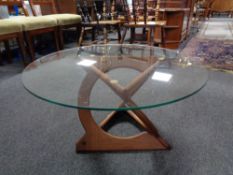 A circa 1970's Soren Georg Jensen designed circular glass topped coffee table on teak sculpted base