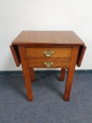 An Edwardian two drawer flap sided chest on raised legs