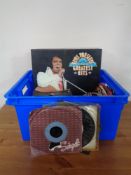 A box containing vinyl LPs and seven inch singles to include Elvis, Village People,