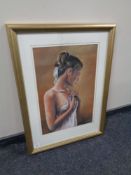 A framed pastel drawing of a female, signed B.