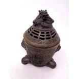 A Chinese embossed bronze incense pot with dragon design