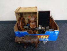 A box containing wooden crates, wooden carvings, animal figures, leather hippopotamus,