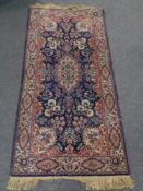 A mcahined Kirman design rug