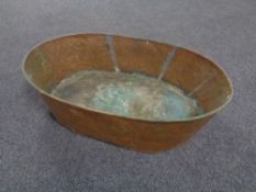 An antique hammered copper wash tub,