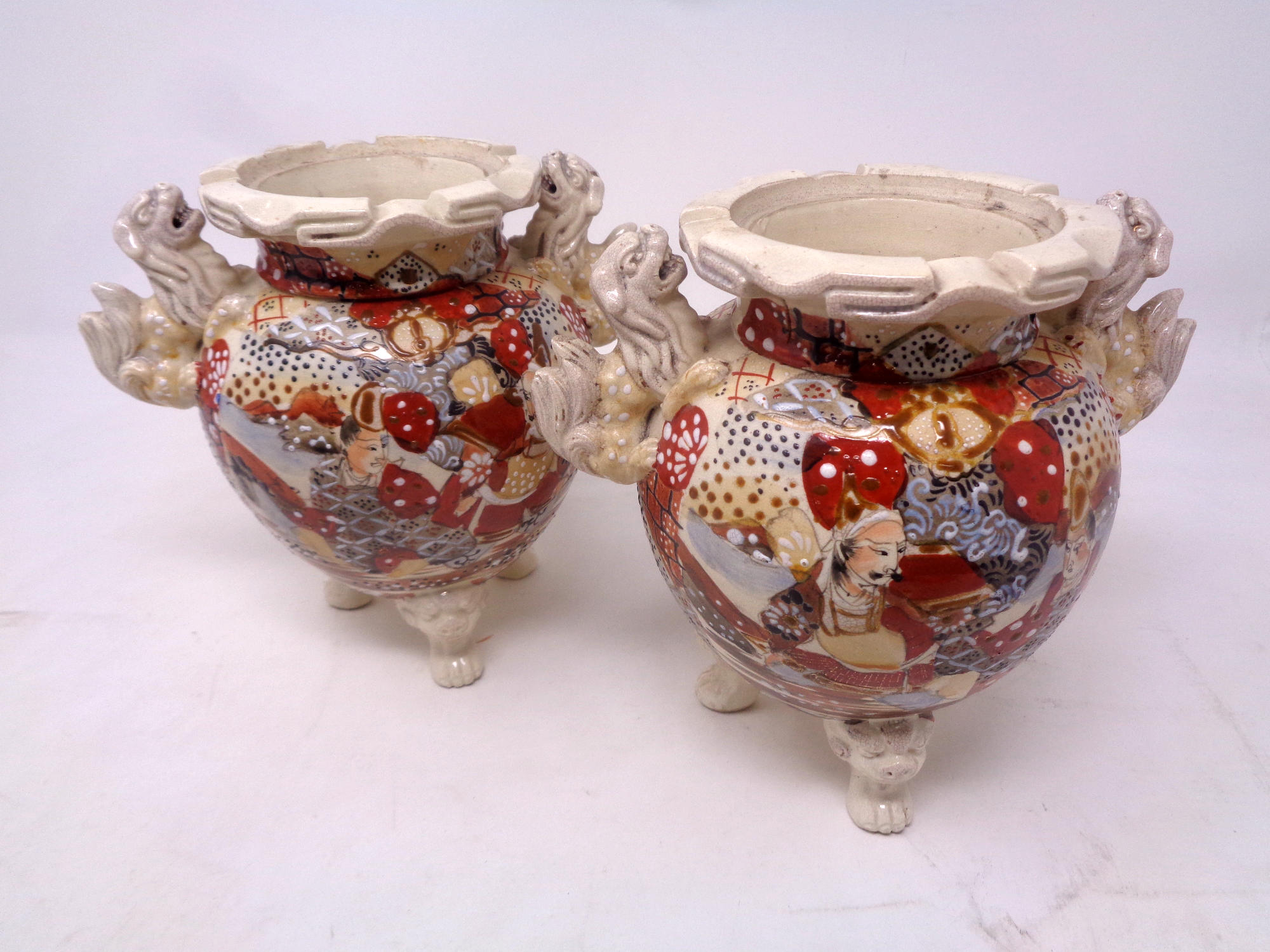 A pair of Japanese Satsuma vases on raised feet, height 16.