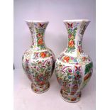 A pair of oriental floral pattern vases depicting geishas in a garden, height 42.