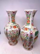 A pair of oriental floral pattern vases depicting geishas in a garden, height 42.