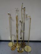 Five brass floor lamps together with a brass table lamp (continental wiring)