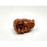 A carved Chinese hardwood netsuke - Tiger in corn husk