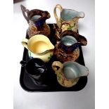 A tray containing an Era ware floral pattern jug together with five further antique jugs to include