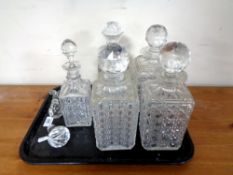 A tray containing four 20th century cut glass decanters together with three further decanter