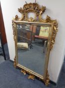 A highly ornate gilt and gesso bevel edged mirror (as found)